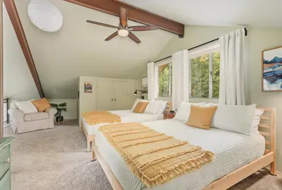 a bedroom with two beds and a ceiling fan at Bearfoot Cabin 15 Min to Yosemite Gate! in Oakhurst
