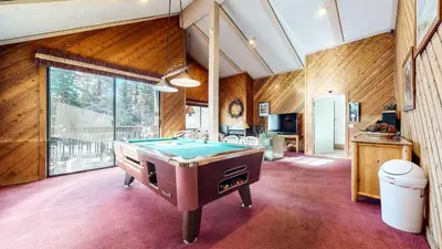 a pool table in a room with wooden walls at Chic 1 BDR Loft with Hot Tub Near Canyon Lodge in Mammoth Lakes