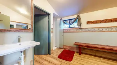 a bathroom with a sink and a toilet and a bench at Chic 1 BDR Loft with Hot Tub Near Canyon Lodge in Mammoth Lakes