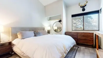 a bedroom with a large white bed and a window at Chic 1 BDR Loft with Hot Tub Near Canyon Lodge in Mammoth Lakes