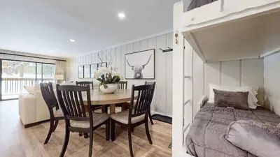 a bedroom and a dining room with a table and a bed at Emerson Escape Incredible Moments at Mammoth in Mammoth Lakes