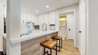 a kitchen with a counter and two stools at Emerson Escape Incredible Moments at Mammoth in Mammoth Lakes