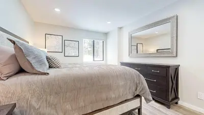 a bedroom with a bed with a dresser and a mirror at Emerson Escape Incredible Moments at Mammoth in Mammoth Lakes