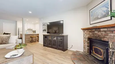 a living room with a fireplace and a tv at Emerson Escape Incredible Moments at Mammoth in Mammoth Lakes