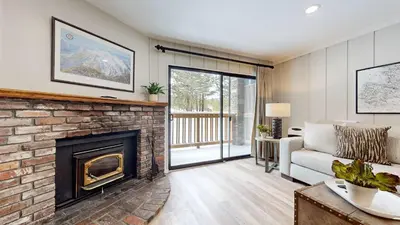 a living room with a fireplace and a couch at Emerson Escape Incredible Moments at Mammoth in Mammoth Lakes