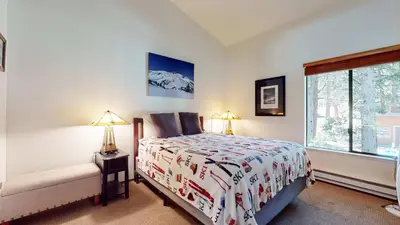 a bedroom with a bed and a window at Escape to The Summit Pool & HT Next Door in Mammoth Lakes