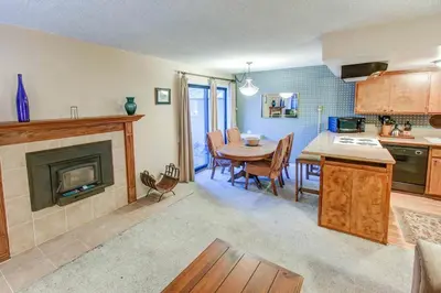 a kitchen and dining room with a table and a fireplace at Fireside Pool Access Hot Tub & More in Mammoth Lakes