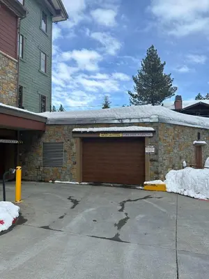 a garage in front of a building with snow at Fireside at The Village Near Hike Bike in Mammoth Lakes
