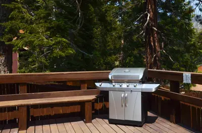 a barbecue grill sitting next to a bench on a deck at Studio with Amenities Walk to Village in Mammoth Lakes