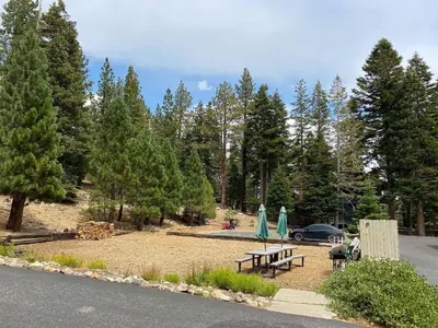 a park with picnic tables and a car and trees at Hidden Valley Homestead Near Hike Bike & More in Mammoth Lakes