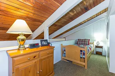a room with a lamp on a dresser in a attic at Horizons 4 Year-Round Outdoor Activities in Mammoth Lakes