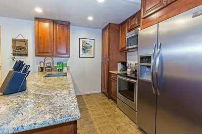 a kitchen with stainless steel appliances and wooden cabinets at Horizons 4 Year-Round Outdoor Activities in Mammoth Lakes