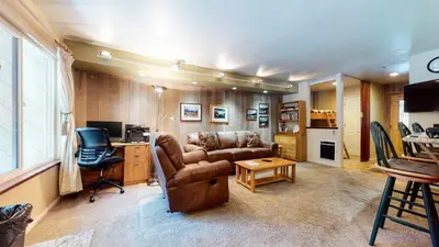 a living room with a couch and a desk at Horizons Communal Sauna & Hot Tub in Mammoth Lakes