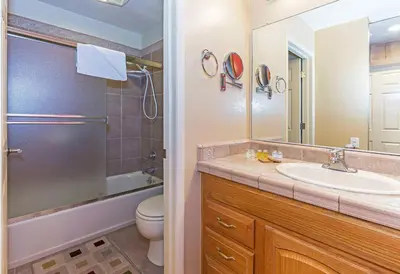 a bathroom with a sink and a toilet and a mirror at Horizons Communal Sauna & Hot Tub in Mammoth Lakes