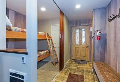 a room with bunk beds and a hallway with a door at Horizons Communal Sauna & Hot Tub in Mammoth Lakes
