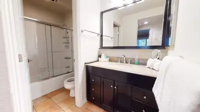 a bathroom with a sink and a toilet and a mirror at Horizons 4 Communal Rec Room & Pool in Mammoth Lakes