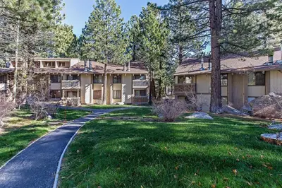 a house with a driveway in front of a yard at Horizons Condo with Communal Clubhouse in Mammoth Lakes