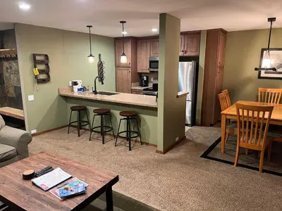 a kitchen and living room with a table and chairs at Horizons Condo with Communal Clubhouse in Mammoth Lakes