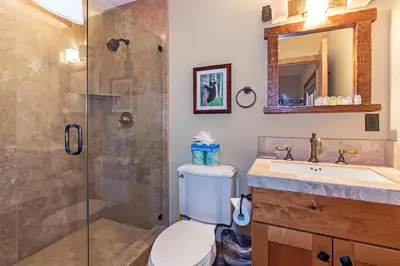 a bathroom with a shower and a toilet and a sink at Stonegate #02 Luxe Condo with Foosball Table in Mammoth Lakes