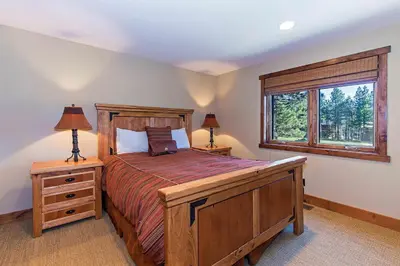 a bedroom with a large bed and a window at Stonegate #02 Luxe Condo with Foosball Table in Mammoth Lakes