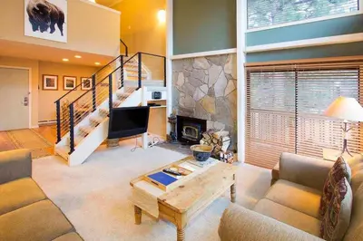 a living room with a couch and a fireplace at Summit #20 Near DT Hike Bike & Ski in Mammoth Lakes