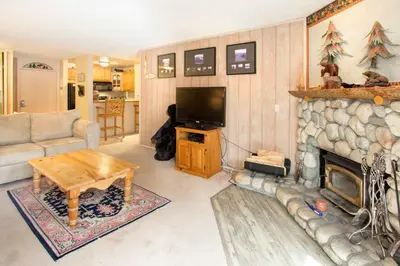 a living room with a fireplace and a television at Summit #217 A Couples Getaway Dream in Mammoth Lakes