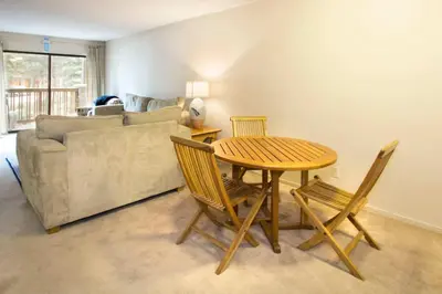 a living room with a table and chairs and a couch at Summit #217 A Couples Getaway Dream in Mammoth Lakes