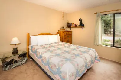 a bedroom with a bed and a dresser and a window at Summit #217 A Couples Getaway Dream in Mammoth Lakes