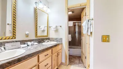 a bathroom with two sinks and a shower at Summit Cozy Condo Getaway in Mammoth Lakes