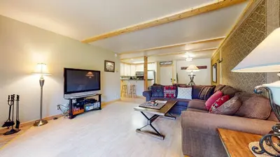 a living room with a couch and a tv at Summit Cozy Condo Getaway in Mammoth Lakes