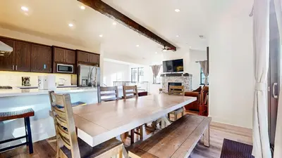 a kitchen and dining room with a wooden table at An Adventure of a Lifetime 3 BDR 5 Min to Skiing in Mammoth Lakes