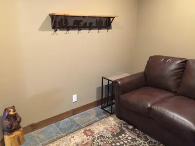 a living room with a leather couch and a shelf at The Lodges by 8th Hole Year-Round Fun in Mammoth Lakes