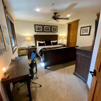 a hotel room with a bed and a desk and a desk at The Lodges by 8th Hole Year-Round Fun in Mammoth Lakes