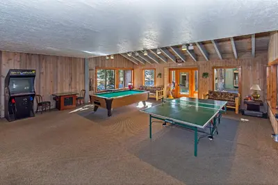 a living room with a pool table and a tv at Viewpoint #131 Walk to Eats & Entertainment in Mammoth Lakes