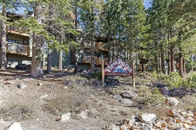 a sign in front of a house in the woods at Viewpoint #131 Walk to Eats & Entertainment in Mammoth Lakes