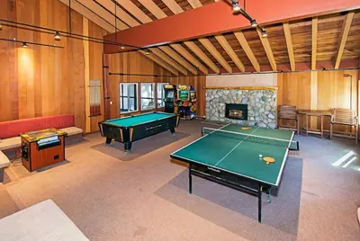 a room with a pool table and a fireplace at Horizons 4 - Year-Round Outdoor Activities in Mammoth Lakes