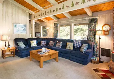 a living room with a blue couch and a table at Villa De Los Pinos #33 Year-Round Activities in Mammoth Lakes
