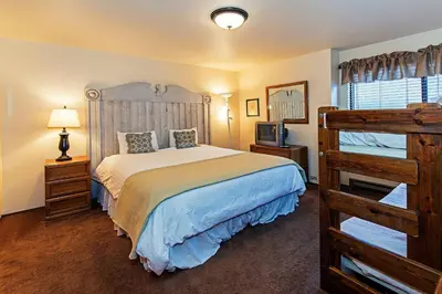 a bedroom with a large bed and a wooden ladder at Horizons 4 - Excellent for Groups in Mammoth Lakes