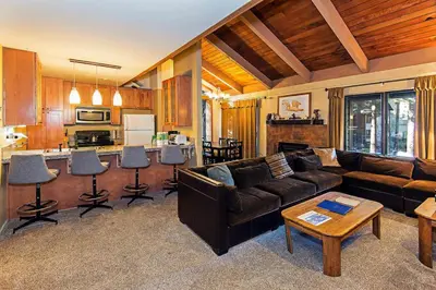 a living room with a couch and a kitchen at Horizons 4 - Walk to Shops & Eateries in Mammoth Lakes