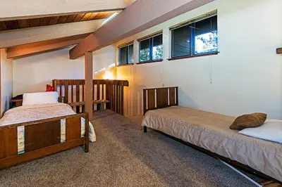 a bedroom with two beds and two windows at Horizons 4 - Walk to Shops & Eateries in Mammoth Lakes