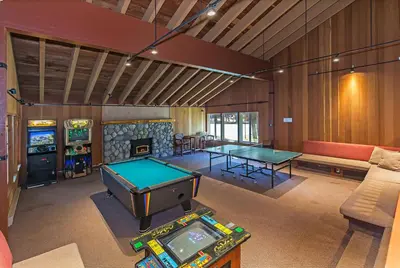 a living room with two ping pong tables and a fireplace at Horizons 4 - Walk to Shops & Eateries in Mammoth Lakes