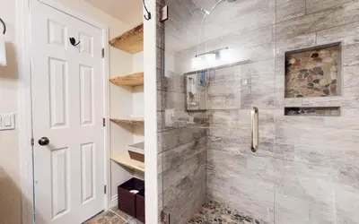 a bathroom with a shower with a glass door at Villa De Los Pinos Year-Round Activities Nearby Shopping & Restaurants in Mammoth Lakes