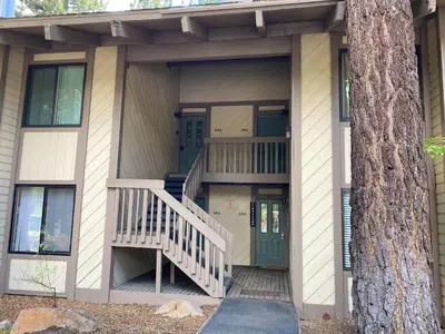 a house with a staircase and a door and a tree at Horizons Bliss - Near Year-Round Activities in Mammoth Lakes