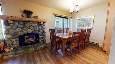 a dining room with a table and a fireplace at Horizons Bliss - Near Year-Round Activities in Mammoth Lakes