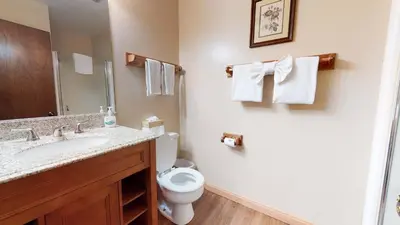 a bathroom with a sink and a toilet and towels at Horizons Bliss - Near Year-Round Activities in Mammoth Lakes