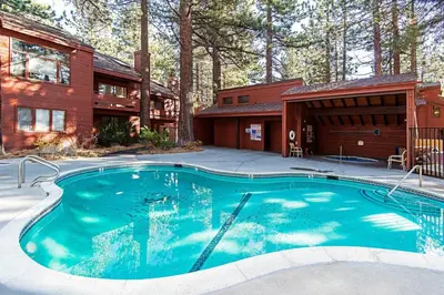 a swimming pool in front of a house at Winterset #02 Shared Hot Tub & Pool in Mammoth Lakes