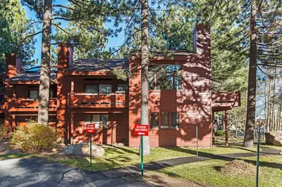 a log home with trees in front of it at Winterset #02 Shared Hot Tub & Pool in Mammoth Lakes