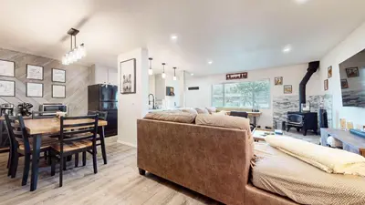 a living room and kitchen with a couch and a table at Jackson's Alpine Retreat - For 4 in Mammoth Lakes