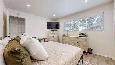 a bedroom with a bed and a dresser and a window at Jackson's Alpine Retreat - For 4 in Mammoth Lakes