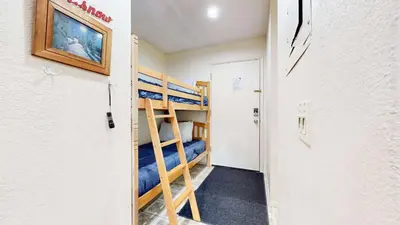 a hallway with bunk beds in a room at Cozy Condo for 4 Near Shuttle & Eagle Lodge in Mammoth Lakes